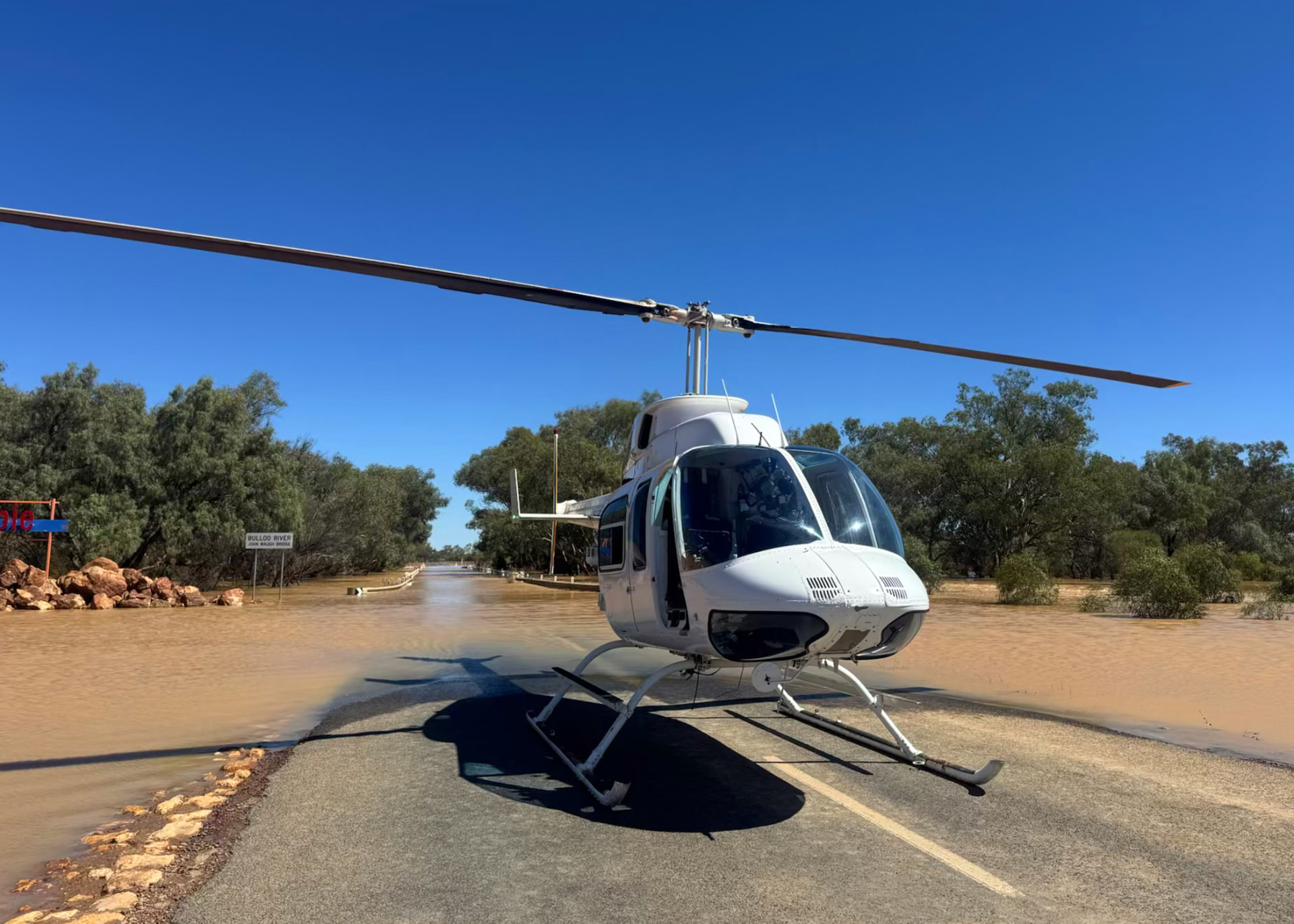 Helicopter operating from a flood-cut road during an access task